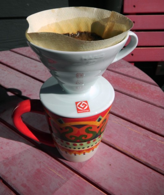 the ceramic version of the hario v60 holds the heat of the water in...