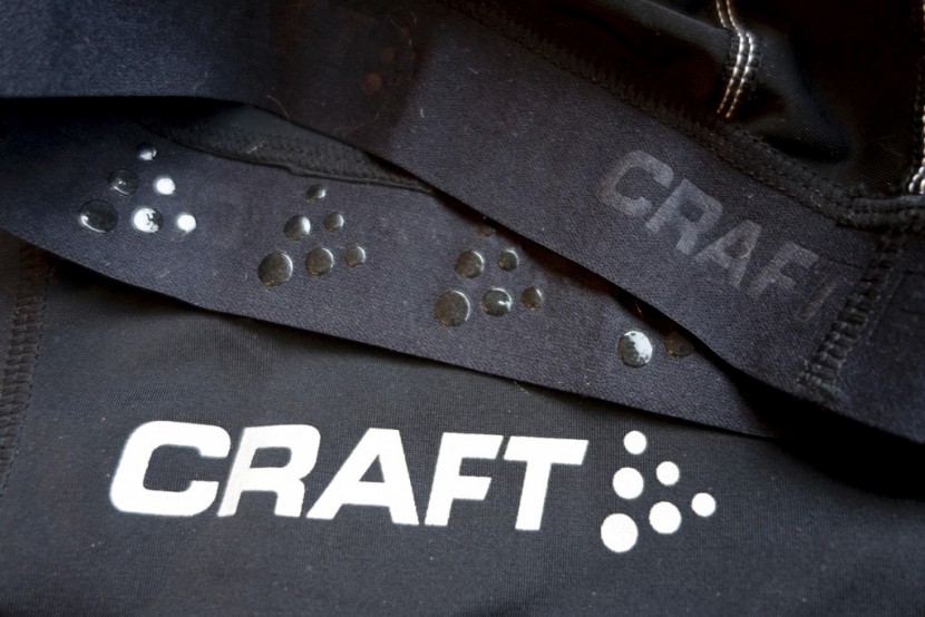 craft performance short - the craft logo in a reflective finish and a detail of the leg cuffs...