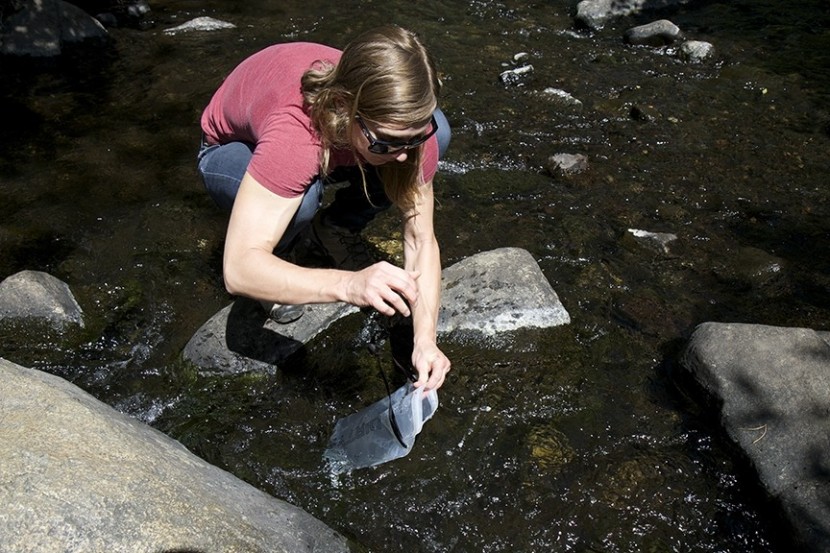 scooping out water to treat with the gravityworks.
