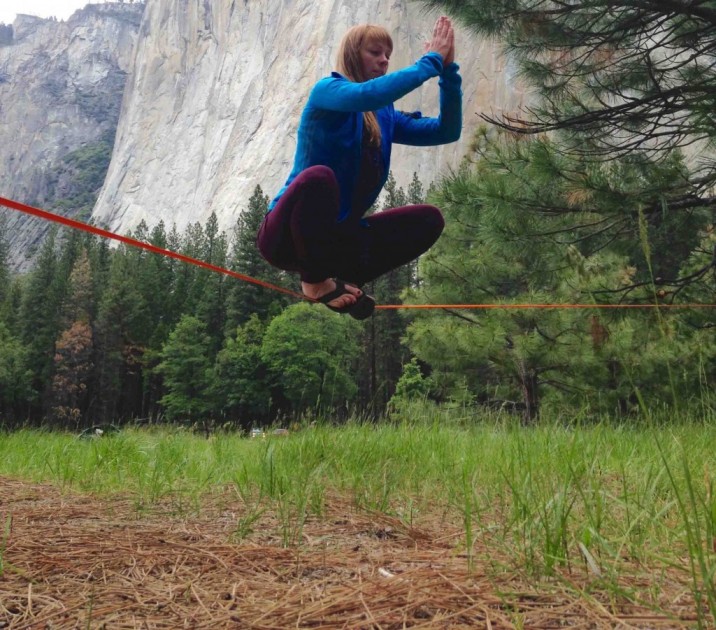 slackline - libby sauter works on her "buddha" pose while practicing static...