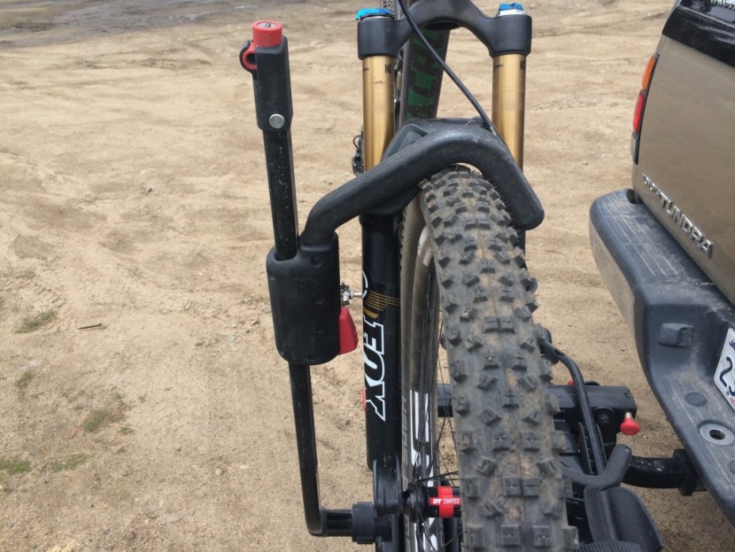 yakima holdup - short cable locks extend out of the top of the ratcheting arm to...