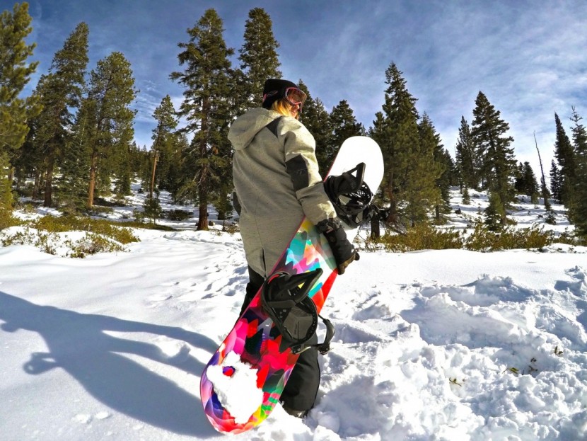 snowboard womens - the rome lo fi rocker gears up for a backcountry hike.