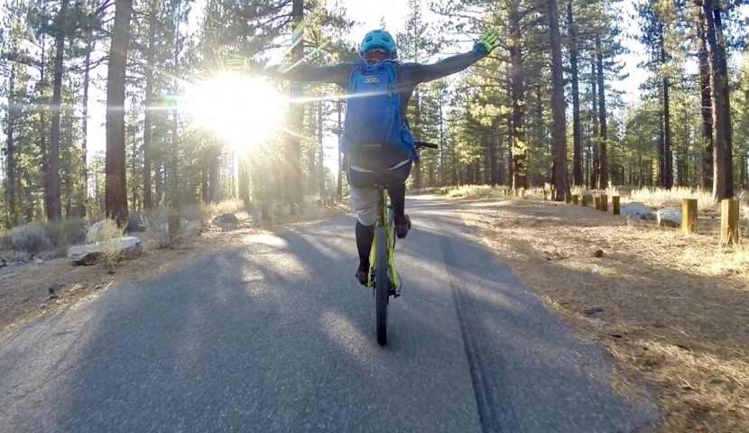 mountain bike pedals - our lead tester using the clipless pedals to help hold up a...
