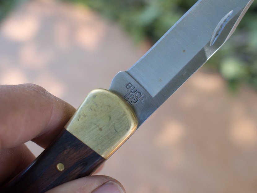 buck 110 folding hunter - the distressed brass and buck embossing on the blade speak to the...