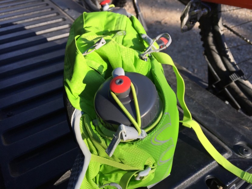 osprey talon 6 - the water bottles secured with bungees in the padded sleeves.