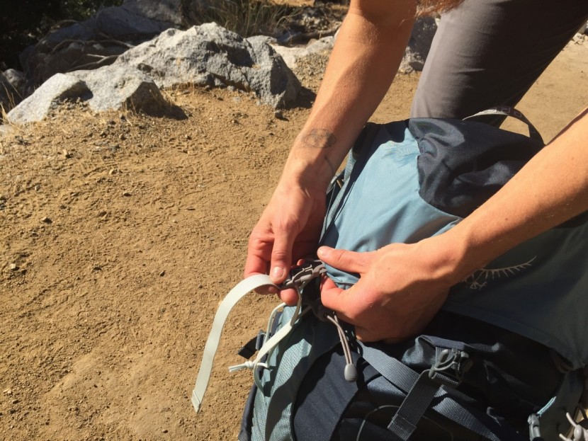 osprey ariel ag 65 - here, the under-lid cover is being buckled. this flap is supposed to...