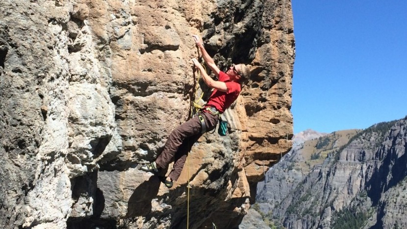 pulling through the low steep moves on a popular climb at the...