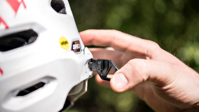 bell super dh mips - the rear release latch to remove the chin bar.