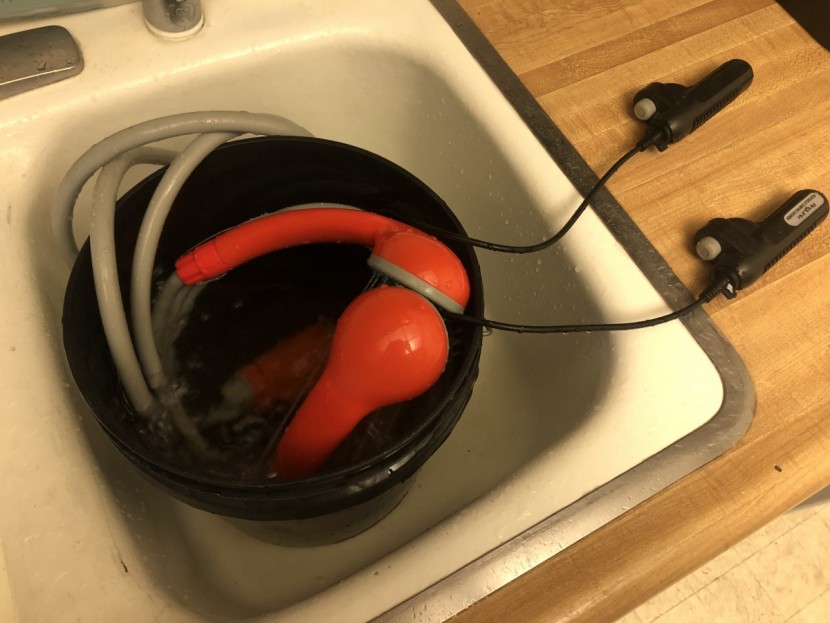 camping shower - two apparently identical orange showers being put head-to-head to...