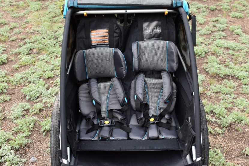 bike trailer - the interior of the d'lite x, showcasing its plush seats and padded...