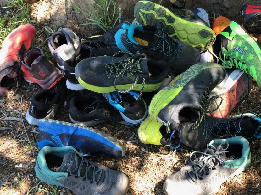 trail running shoes men - a large pile of trail running shoes for testing in 2019.