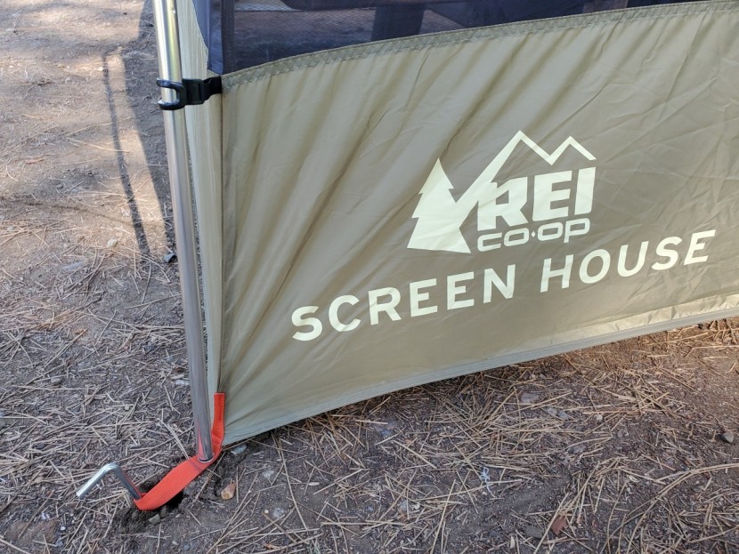 rei co-op screen house - the tent is secured with aluminum stakes. stakes are easy to push...