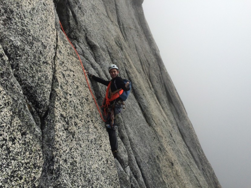 mammut revelation - coiling half of the rope over the shoulder in a mountaineers coil in...