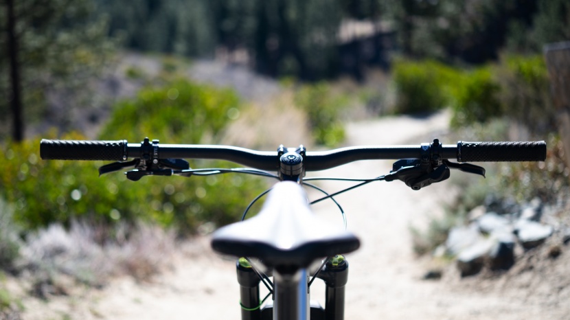 the cockpit setup is dialed with a short stem, wide handlebar, and a...