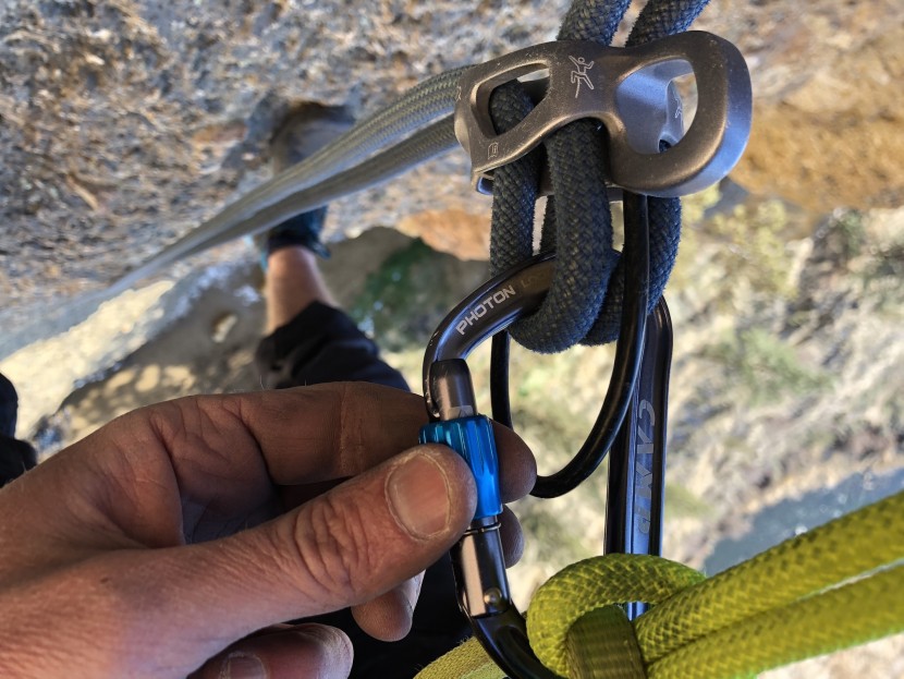locking carabiner - screwing the gate closed while testing it on a double rope rappel...