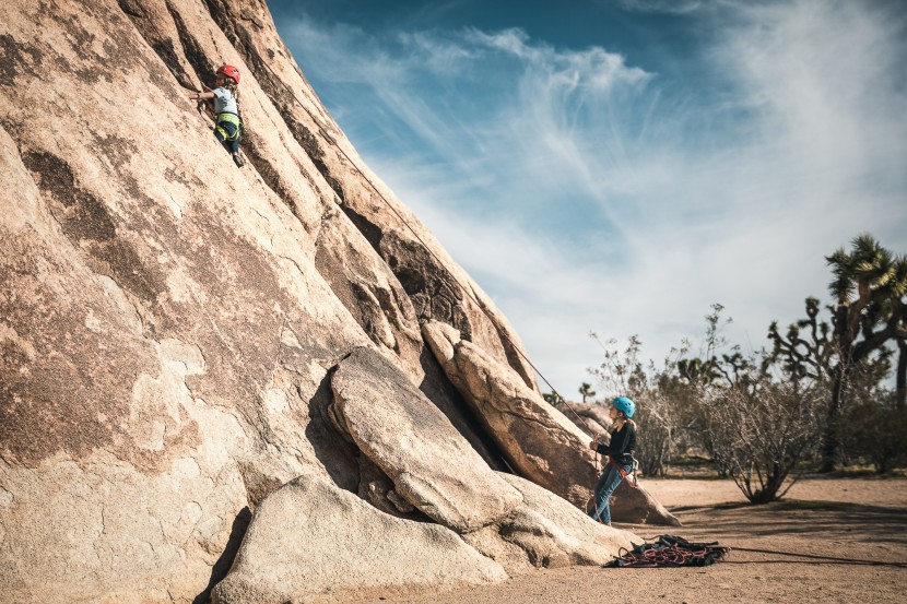 climbing harness kids - sisters climbing together at joshua tree.