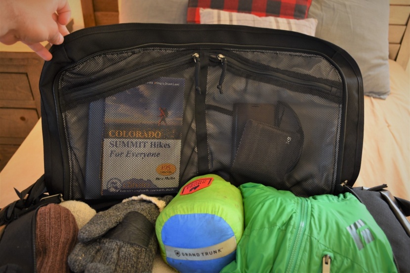 a wide-opening d-shaped zipper reveals a large main storage...