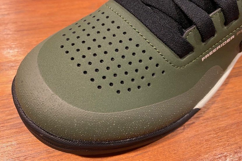 the tough synthetic upper features an armored toe box with exterior...