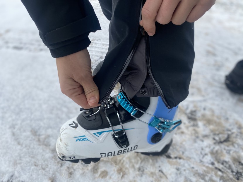 the legs of the pants feature gaiters, as well as zippered access to...