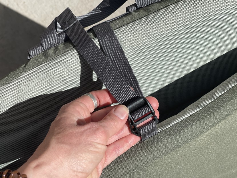 a simple hook with an adjustable strap holds the chair closed for...