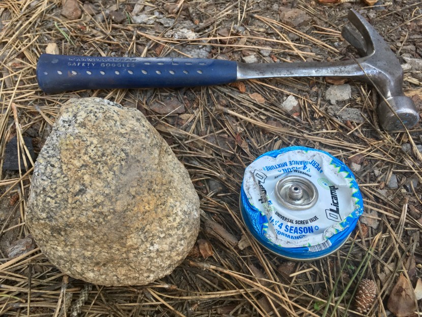 backpacking stove - a flattened canister ready for recycling. a hammer is a good tool...