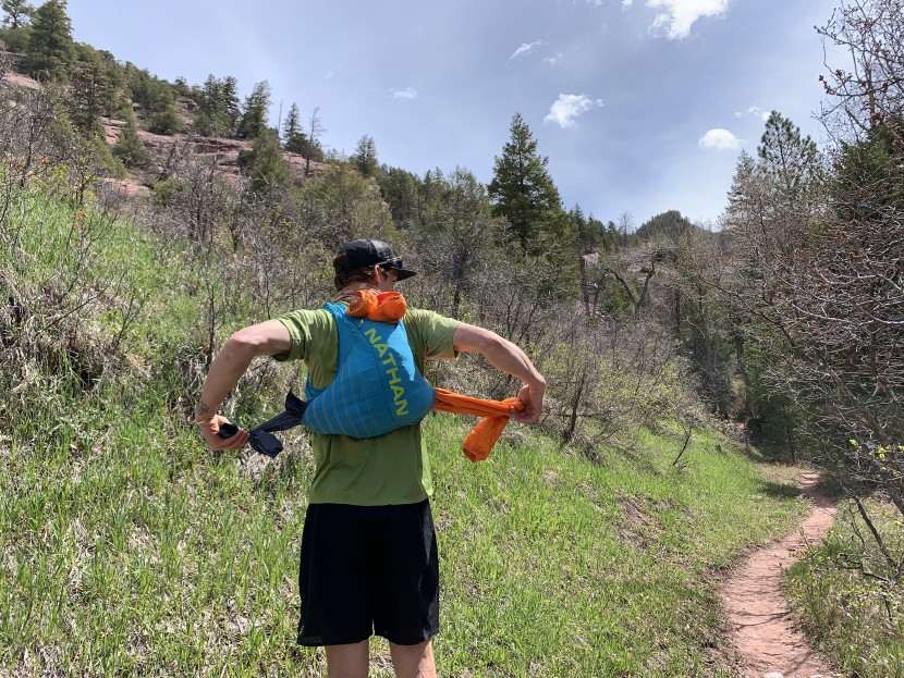 nathan pinnacle 12l - a larger side-access kangaroo pocket, vertical back pocket with side...