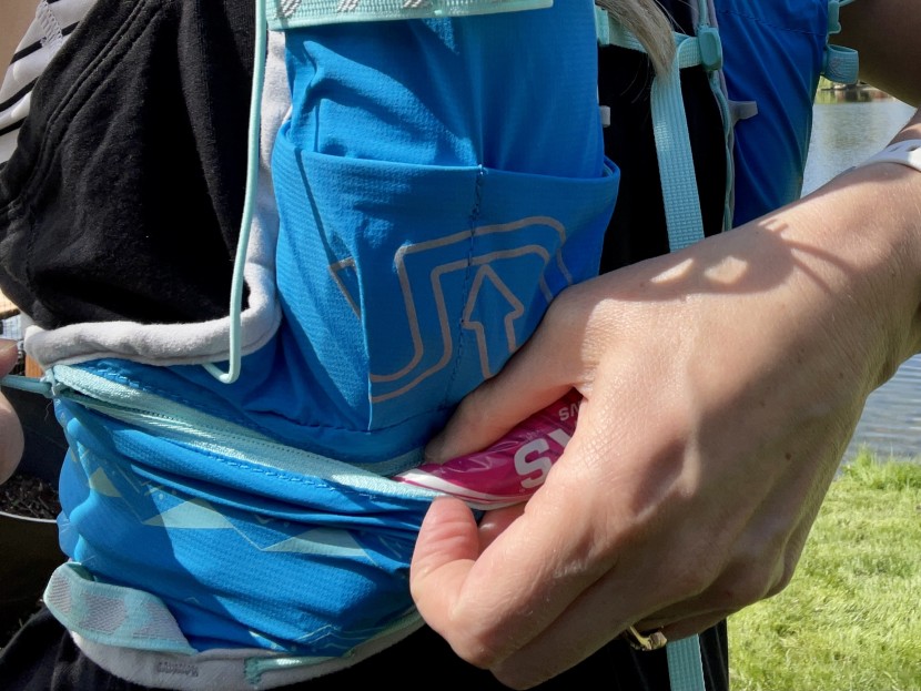 ultimate direction ultra vesta 5.0 for women - the wide zippered pocket is one of our favorites on this pack.