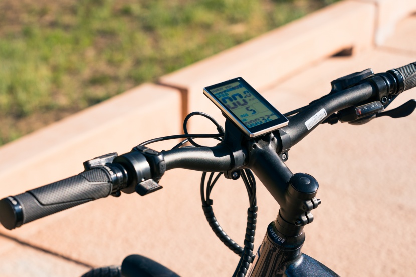 aventon level step-thru - the button controls and thumb paddle throttle are located next to...