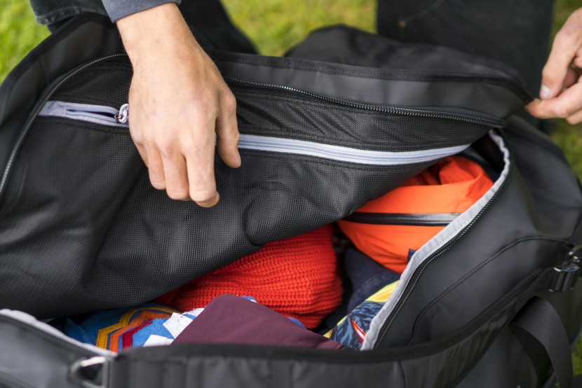 this duffel has two large pockets on the outside of the bag and a...