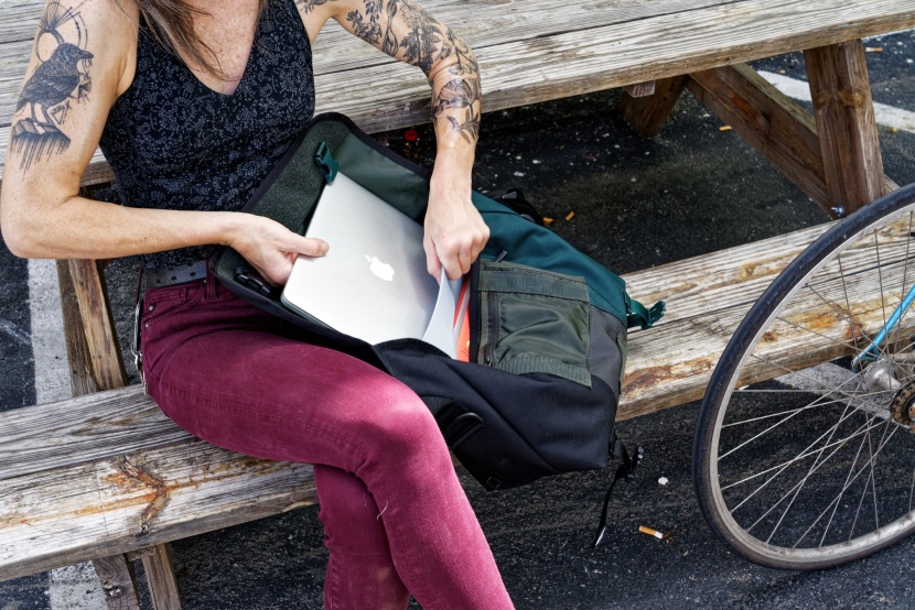 timbuk2 classic - the back compartment has enough space for a 15" laptop. however, it...