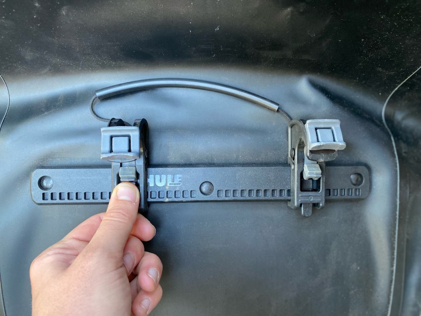 sliding the hook latches along an adjustment rail to adjust the...