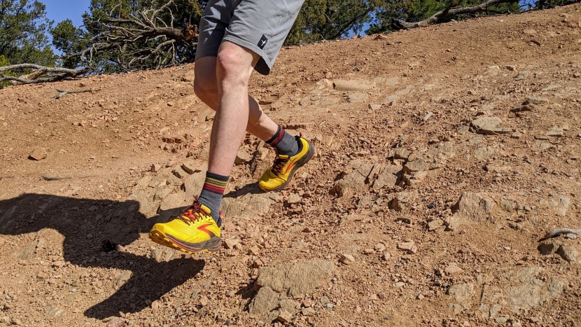 trail running shoes men - thick midsoles, rigid rock plates, and stiff construction all...