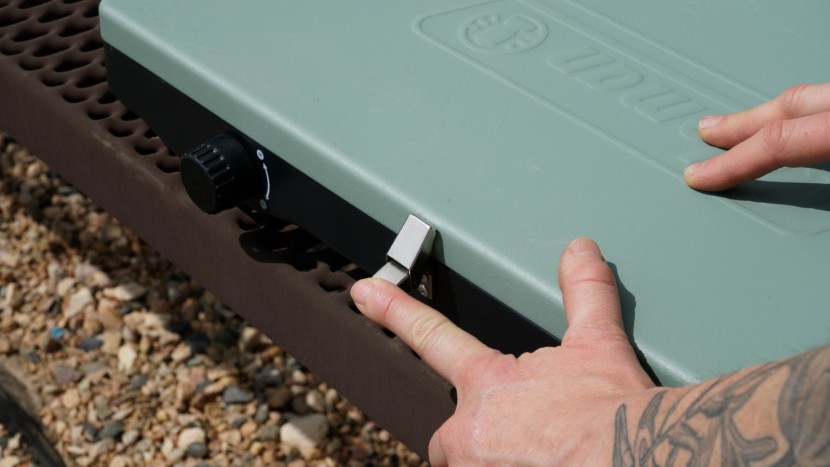 coleman cascade classic - to secure the stove latch, you press down on the bottom metal tab...