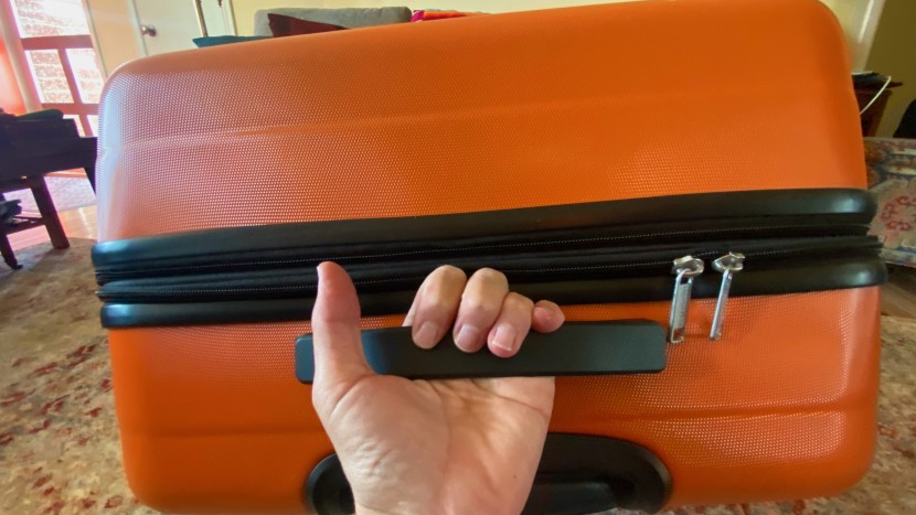 amazon basics 30" hardside spinner - load handle in use on the amazon basics expandable spinner bag.