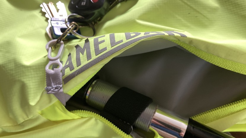 the front pocket features a key holder and an elastic strap that can...