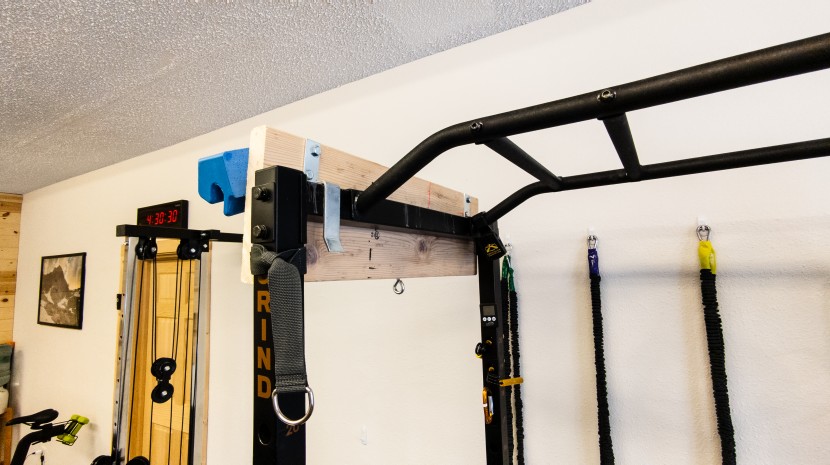 a creative way to mount a board on a squat rack.