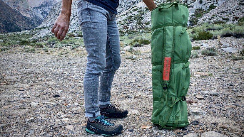 a wide shoulder strap helps to ease the burden of this heavy load.