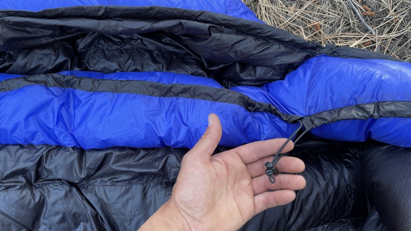 western mountaineering ultralite - the draft collar uses a stretchy cord for adjustment. this lets you...