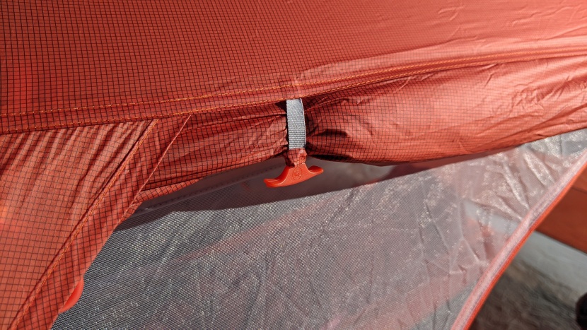 the fabric loops that grab plastic toggles to hold the doors back...