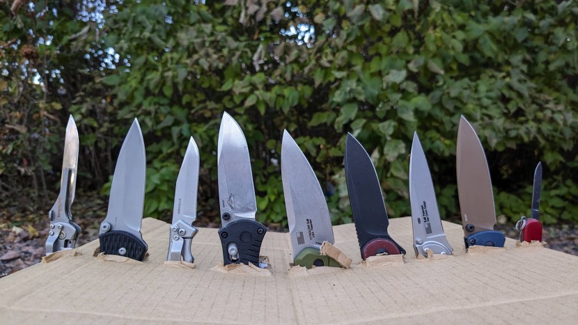 a selection of our tested pocket knives. notice the variety of blade...