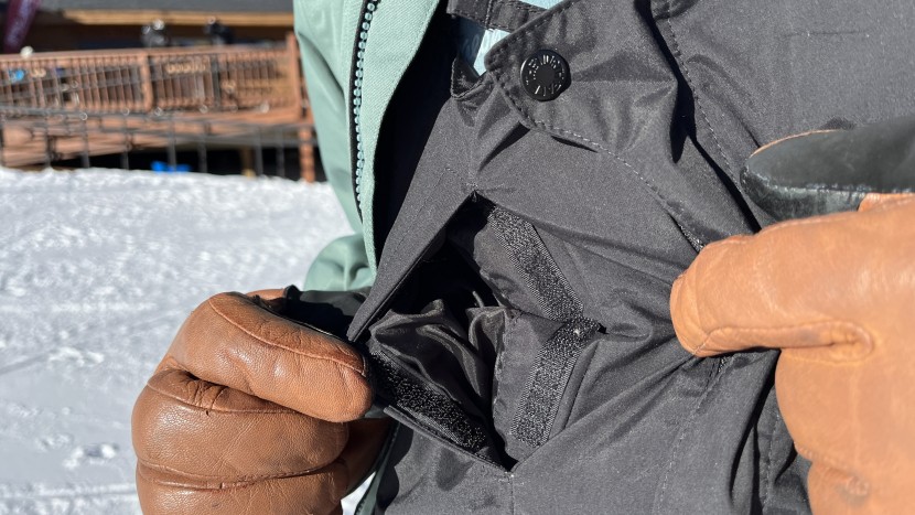 the chest pocket has a vertical opening and a hook-and-loop closure...