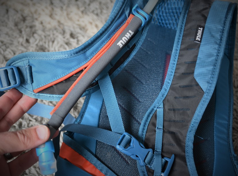 hydration pack - thule's retrakt drinking hose has a flexible magnetic strip to keep...