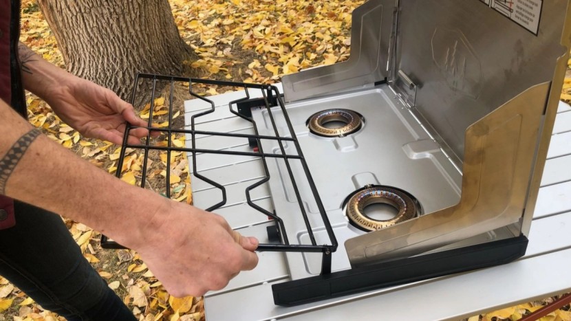 camping stove - cleaning the pinnacle pro's drip pan requires unhooking the grate...