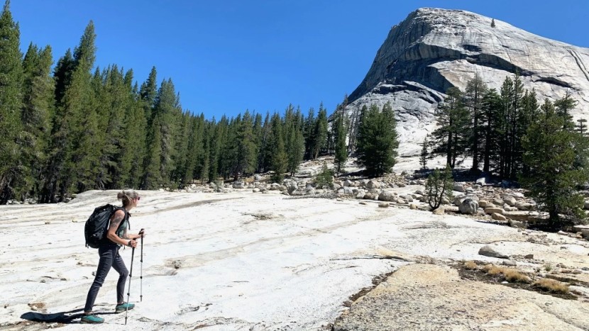 mary testing poles on a backpacking trip through the sierra mountains.
