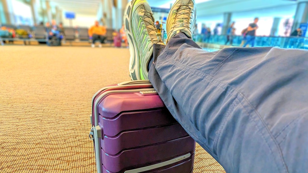 samsonite freeform spinner - using our sturdy freeform spinner as a footstool while we wait at...