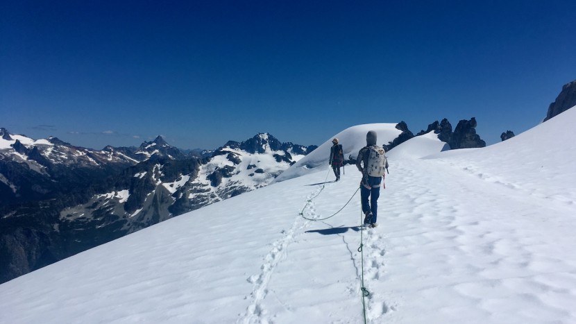 climbing rope - crossing a glacier on the way to an alpine rock route requires a...