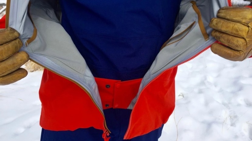 a powder skirt keeps snow out of the hem of the jacket, and internal...