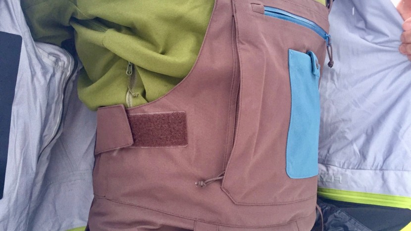 ski pants men - the flylow baker bib has three useful pockets on the torso.