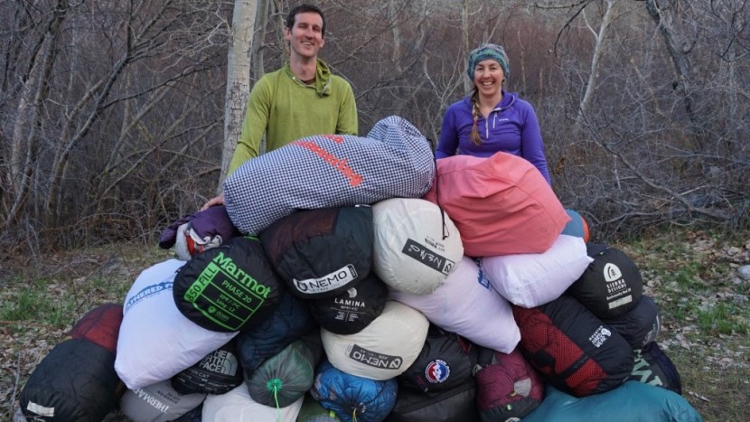 backpacking sleeping bag - two of our sleeping bag reviewers pose with a pile of countless...