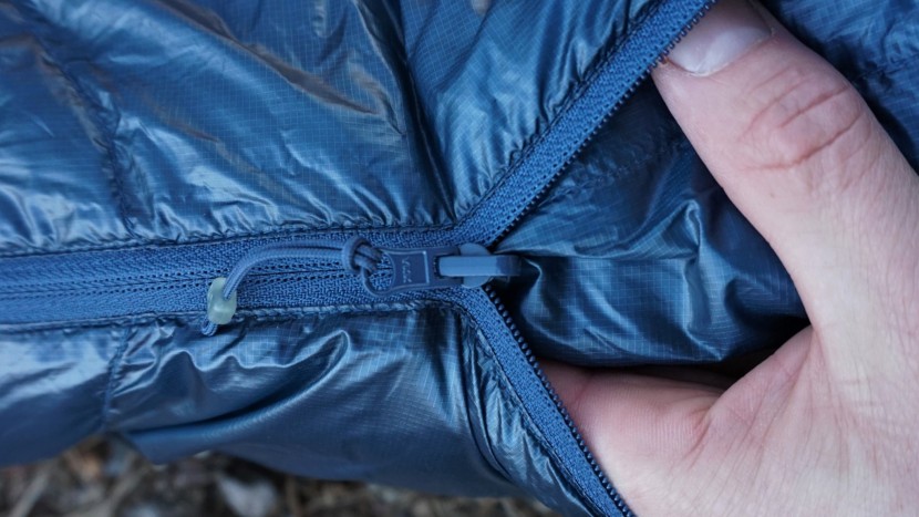 backpacking sleeping bag - the tiny weight-saving zipper on this ultralight bag is...